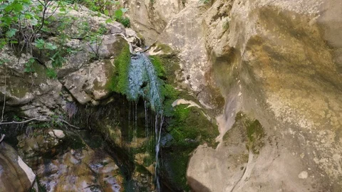 The stream falls from a height into a mountain lake Stock Footage 90620853