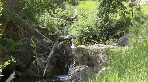 A  Stream falls into pools of water to Exude Nature's Beauty Stock Footage 40501097