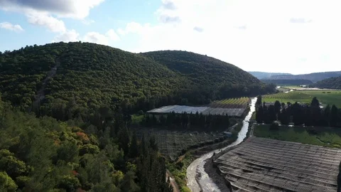 Stream in fields, under green mountains Stock Footage 126946606