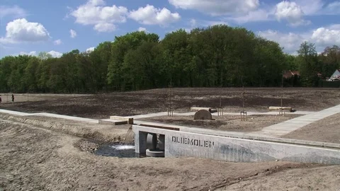 Stream flowing across the foundations of a former paper mill Stock Footage 73344581