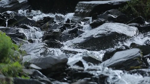 The stream flowing among the stones in spring season Video stock 87746573