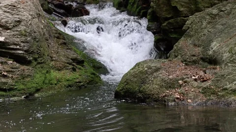 Stream flowing between rocks Stock Footage 200992668