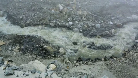 Stream flowing down the slope on a rocky land Stock Footage 77450182