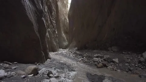 A stream flowing into a gorge among high rocks, Karadakh gorge Video stock 164328882