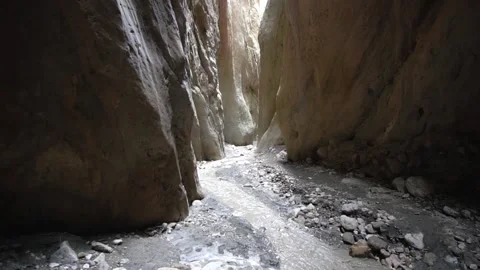 A stream flowing into a gorge among high rocks Video stock 165238908