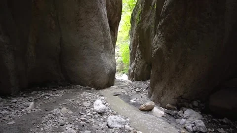 A stream flowing into a gorge among high rocks Video stock 165362580
