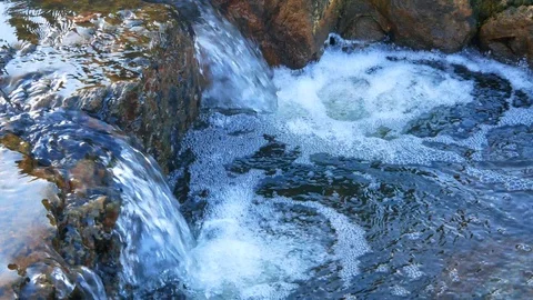 A stream flowing over rocks Stock Footage 91327785