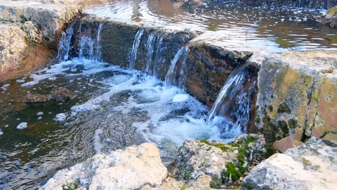 Stream flowing over rocks Stock Footage 91327932