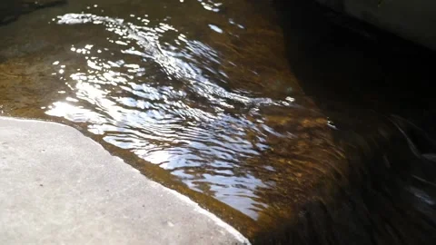 Stream flowing over rocks Stockbeeldmateriaal 211820619