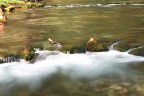 Stream flowing over rocks Stock Photos