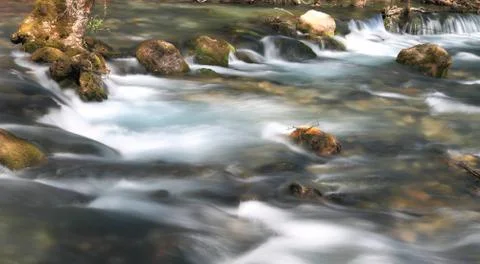 Stream flowing over rocks Stock Photos