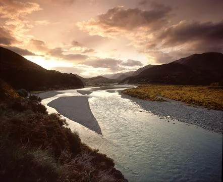 Stream flowing into the sunset scenic Stock Photos