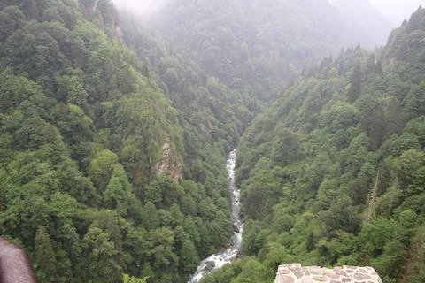 Stream flowing through mountains Stock Photos