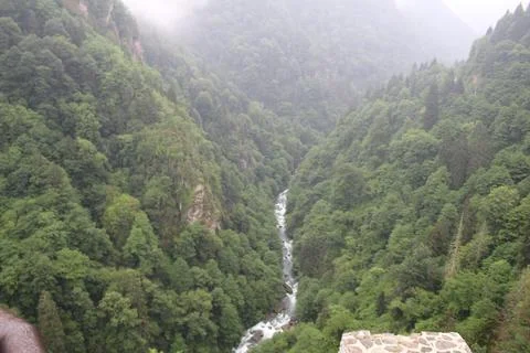 Stream flowing through mountains Stock Photos