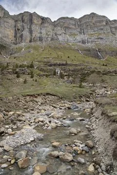 Stream flowing through ordesa valley mountains in pyrenees Stock Photos