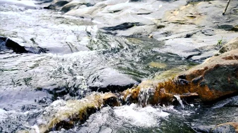 Stream flowing through rocks on a mountain Stockbeeldmateriaal 208090458