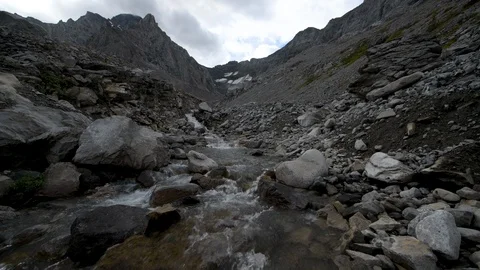 Stream flowing through a rocky mountain landscape Video stock 117968293