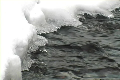 Stream flowing under ice and snow Video stock 65683