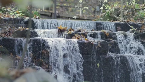 Stream flowing water in cascade waterfalls, slow motion trangul scene Stock Footage 257938976