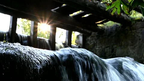 Stream flows and the sun's rays shine from under the old bridge 動画素材 136315083