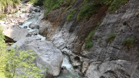 Stream flows between the mountains in uncontaminated natural environment Stock Footage 311938405