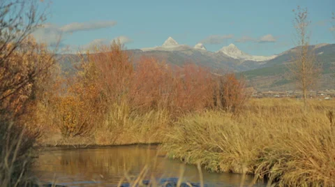 A stream flows with the Teton mountain range in the background Stock Footage 36319216
