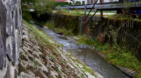 Stream flows through the village Stock Footage 56279562