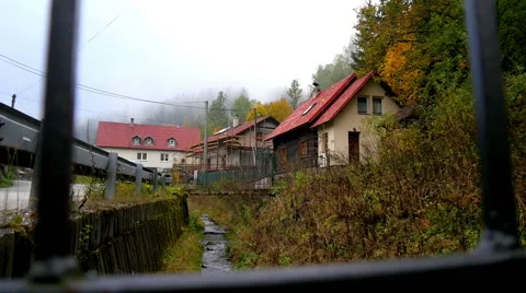 Stream flows through the village Stock Footage 56279684