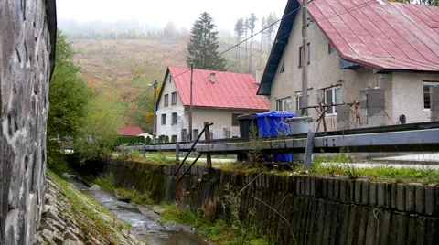Stream flows through the village Stock Footage 56279707