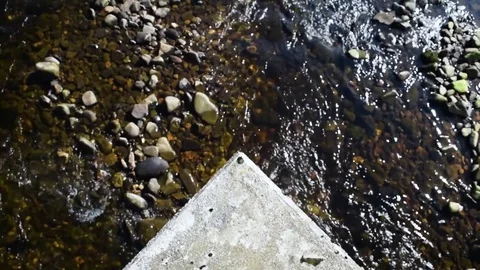A Stream Flows Under a Bridge on a Sunny Day 動画素材 81717079