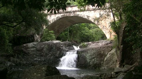 Stream flows under an old bridge Stock Footage 863809