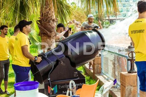 A stream of foam escapes from the foam generator. A foamy party on the beach Stock Photos