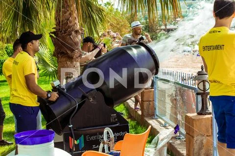 A stream of foam escapes from the foam generator. A foamy party on the beach Stock Photos
