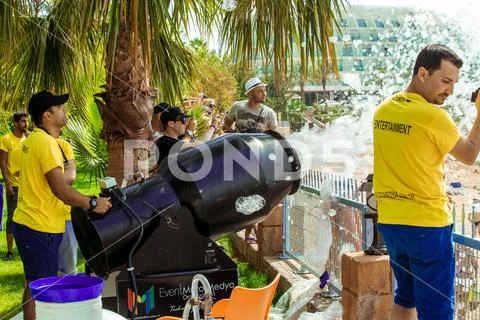 A stream of foam escapes from the foam generator. A foamy party on the beach Stock Photos