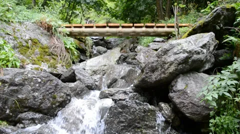 Stream with footbridge Stock Footage 24185166