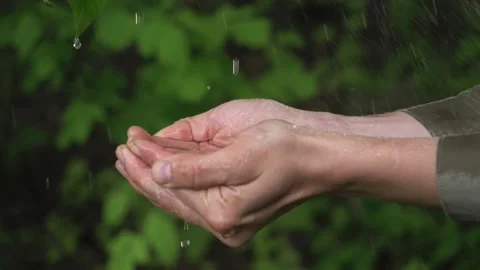 Stream of fresh clean water pouring into human hands, drought land on the Stock Footage
