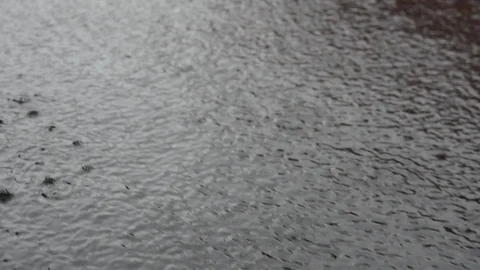 A stream of gray rainwater with traces of falling drops 스톡 동영상 126004732