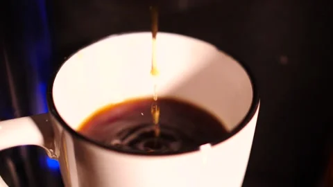 Stream of hot coffee being poured into a mug Stock Footage 153663183