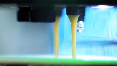 A stream of hot latte coffee pours into a cup from a coffee machine, close-up Stock Footage 266395455