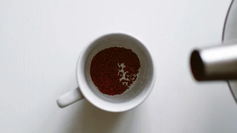 Stream hot water flow pour into instant black coffee Stock Footage 104557192