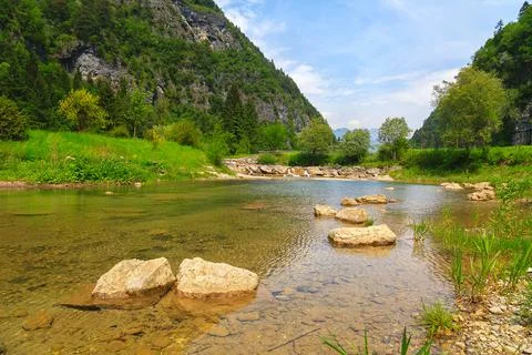 Stream with its refreshing water between the mountain peaks Stock Photos