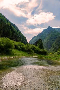 Stream with its refreshing water between the mountain peaks Stock Photos
