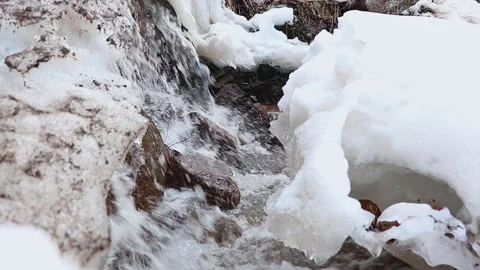 The stream melts snow in the spring Stock Footage 127711540