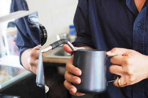 Stream milk with coffee machine Stock Photos