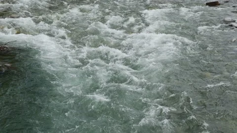 The stream of the mountain stream. Close-up on the water. Slow motion. Stock Footage 155153343