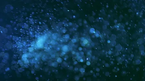 The stream of particles and bubbles on the dark background Stock Footage 69794846