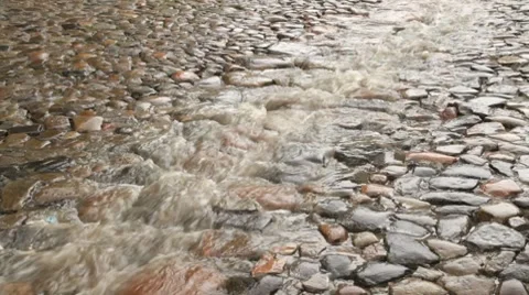 Stream of rain on the cobble road Video stock 7729265