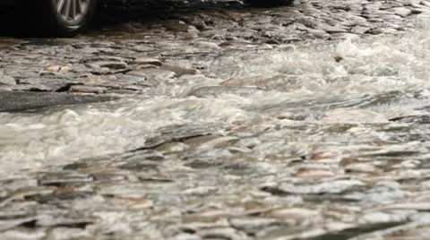 Stream of rain on the cobble road Stock Footage 7729277