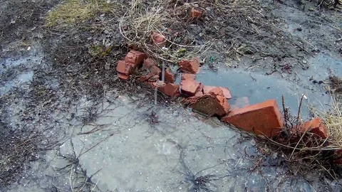 A stream of rainwater hits the puddle Video stock 74381492