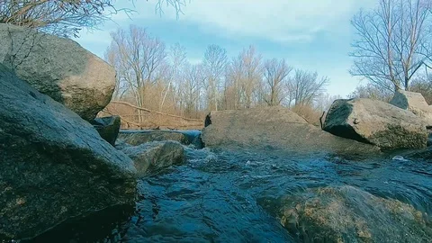 The stream of the river among the gray stones Video stock 104432659